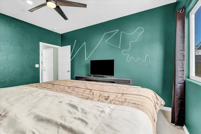 a bathroom with a sink a toilet and a large mirror