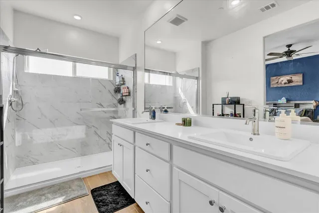 a view of a house with a small yard and wooden fence
