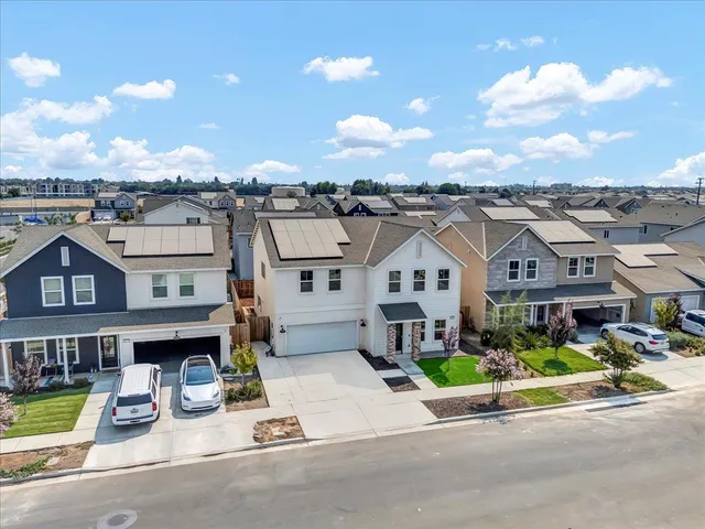 a view of multiple houses with a street