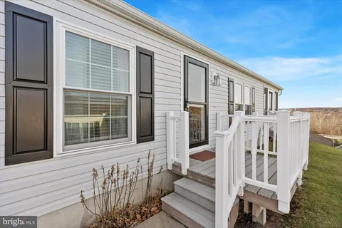 a view of wooden house with a large windows