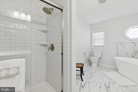 a bathroom with a toilet a sink and shower
