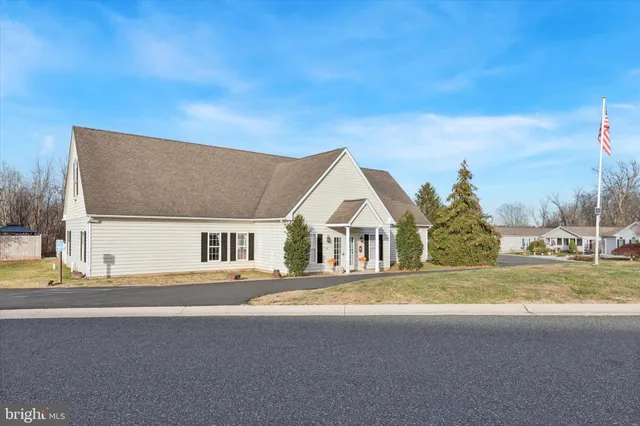 a front view of a house with a garden and yard