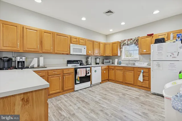 a kitchen with a refrigerator sink and cabinets