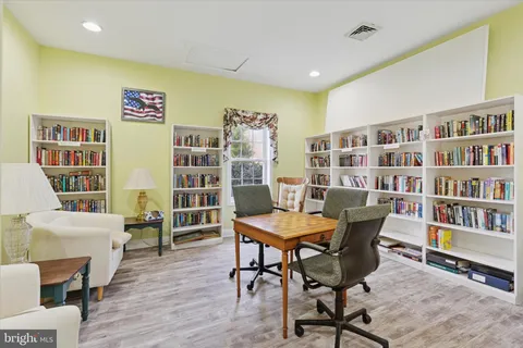 a view of a livingroom with furniture and book shelf