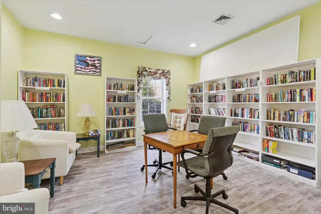 a view of a livingroom with furniture and book shelf