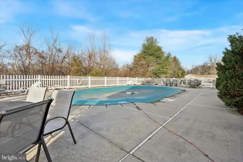 a view of a patio with table and chairs with wooden floor and fence