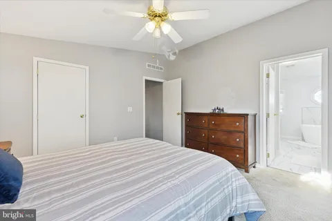 a bedroom with a bed and a dresser