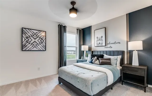 a bedroom with a large bed and a chandelier