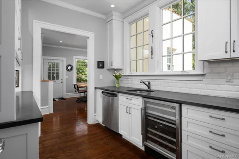 a kitchen with a sink cabinets and wooden floor