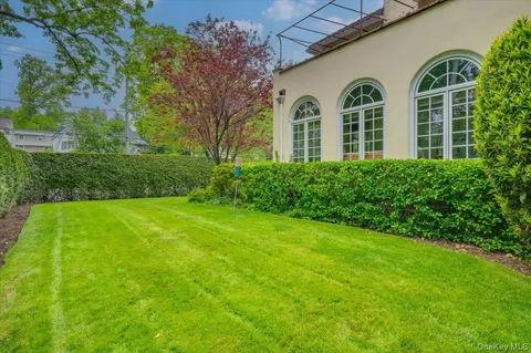 a view of a front of house with yard and green space