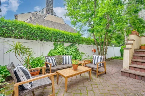 a view of a chairs and table in backyard of the house