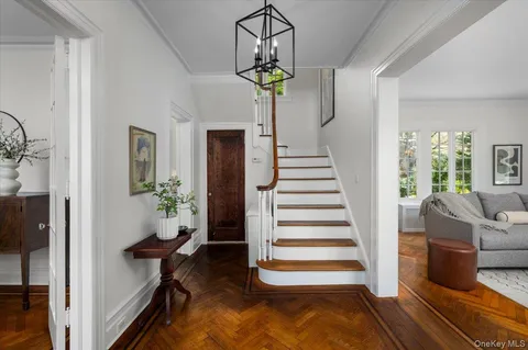a view of entryway and hall with wooden floor