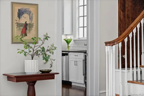 a view of a hallway with furniture and wooden floor