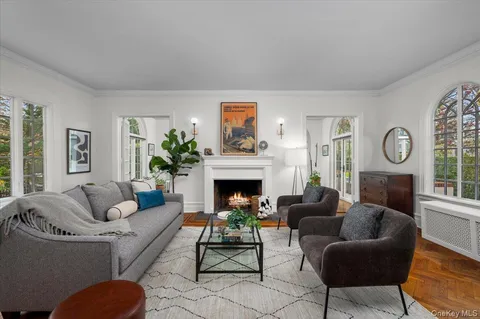 a living room with furniture a fireplace and a window