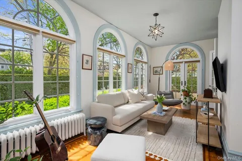 a living room with furniture a fireplace and a large window