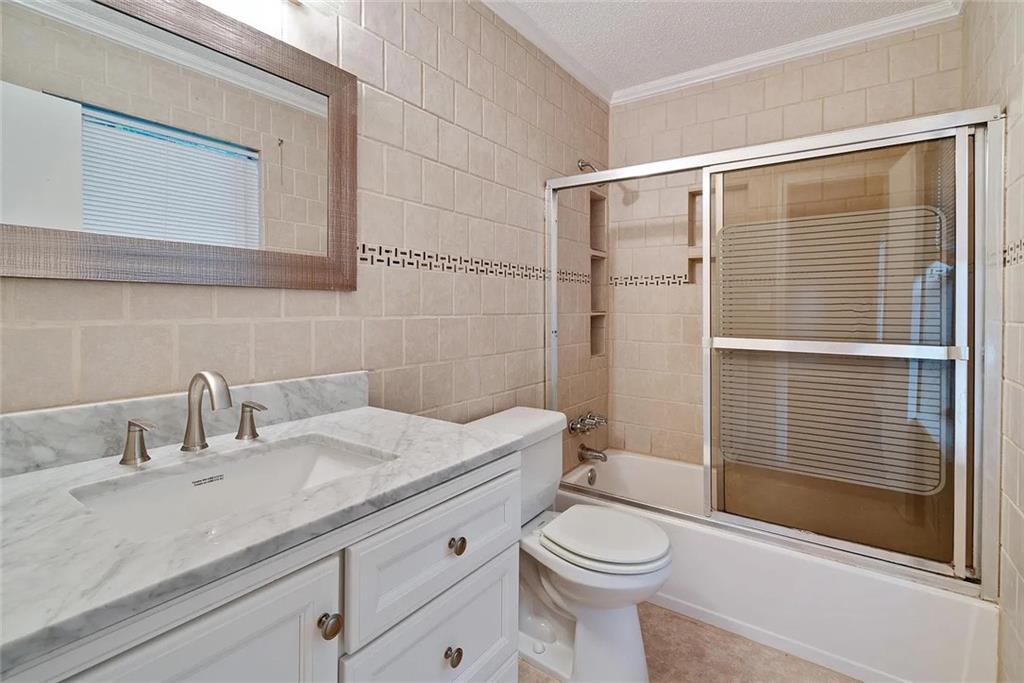 9825 Coleman Road Roswell, GA 30075 - Photo 14 of 17 a bathroom with a sink a toilet and shower