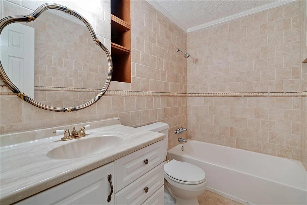 9825 Coleman Road Roswell, GA 30075 - Photo 15 of 17 a bathroom with a sink and a mirror
