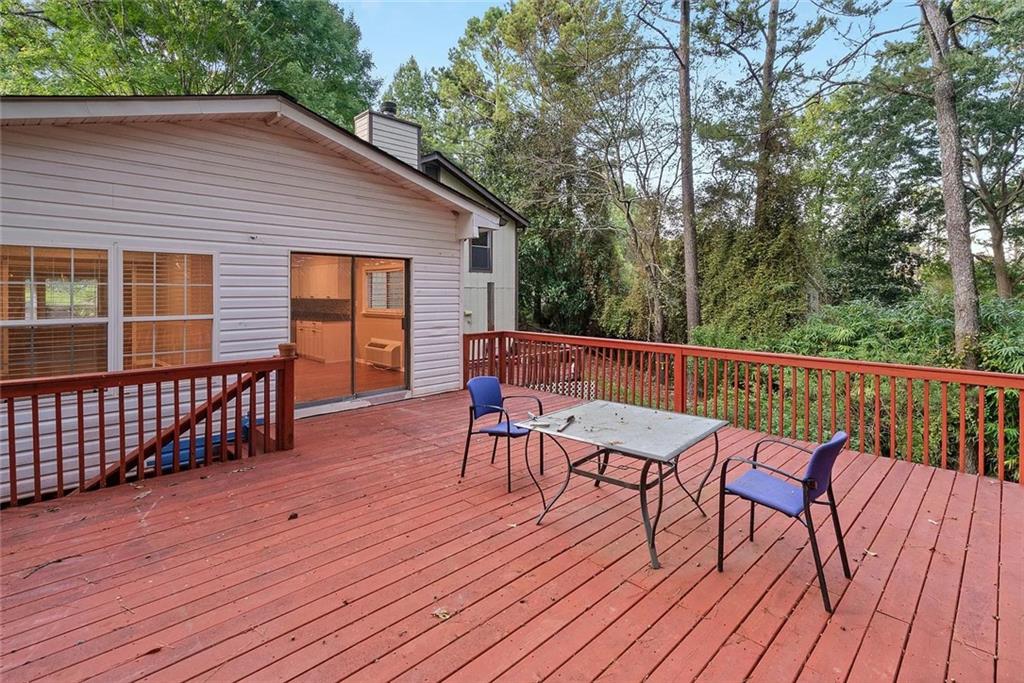 9825 Coleman Road Roswell, GA 30075 - Photo 16 of 17 a view of deck with table and chairs and wooden floor