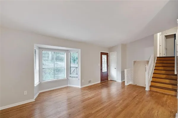 wooden floor in an empty room with a window