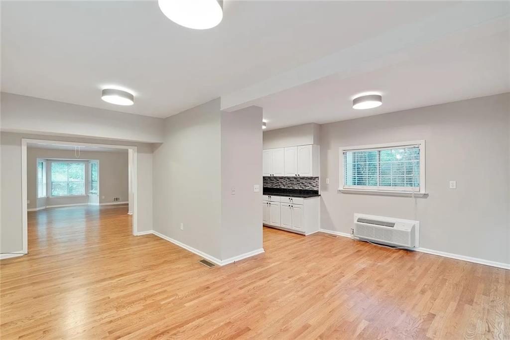 9825 Coleman Road Roswell, GA 30075 - Photo 7 of 17 a view of empty room with wooden floor and window