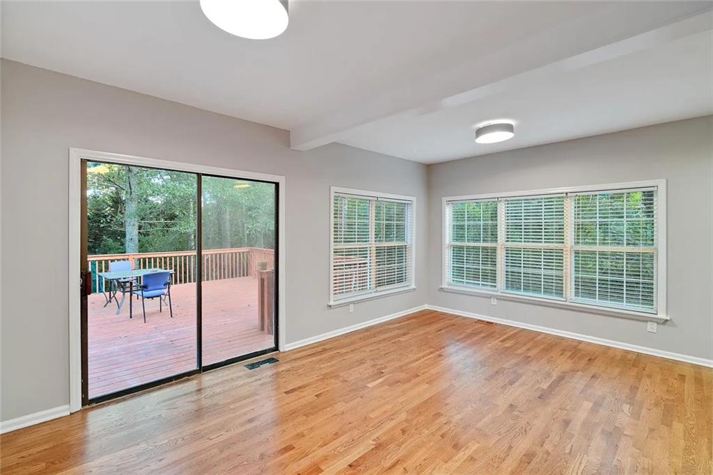 9825 Coleman Road Roswell, GA 30075 - Photo 10 of 17 a view of an empty room with a window and wooden floor