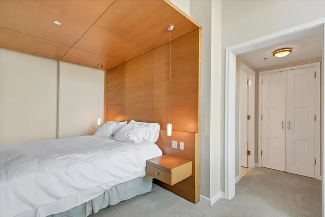 a bedroom with a bed and a night stand