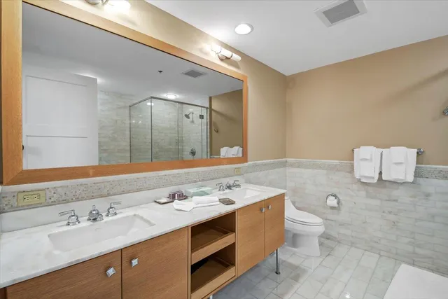 a bathroom with a double vanity sink and a mirror