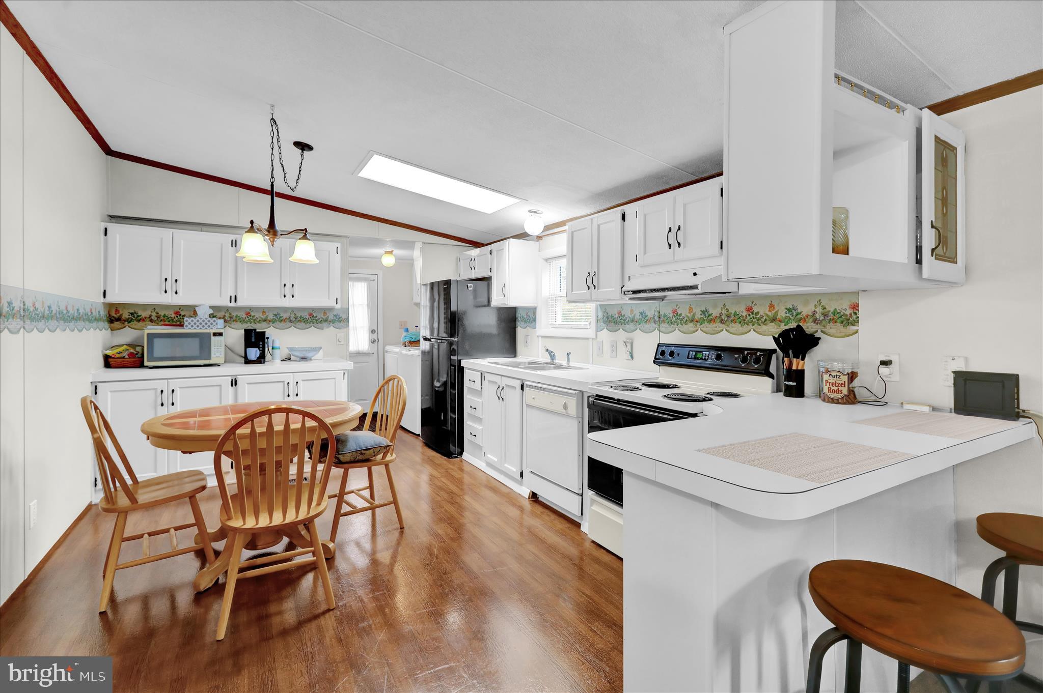 8758 Turkey Ridge Road Breinigsville, PA 18031 - Photo 15 of 29 a kitchen with stainless steel appliances kitchen island granite countertop a dining table chairs stove refrigerator and cabinets