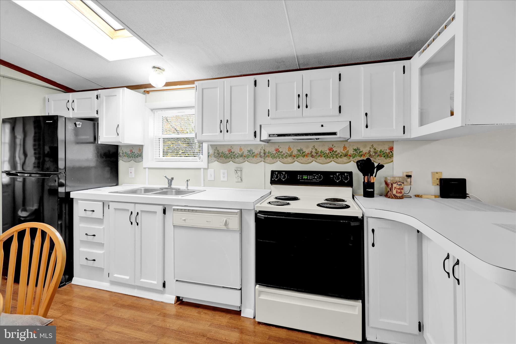 8758 Turkey Ridge Road Breinigsville, PA 18031 - Photo 16 of 29 a kitchen with white cabinets sink and stainless steel appliances
