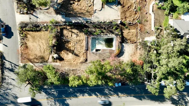 an aerial view of residential house with yard and parking