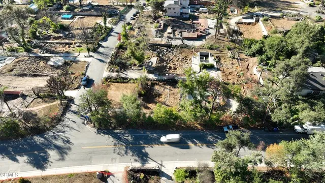an aerial view of a residential houses with outdoor space