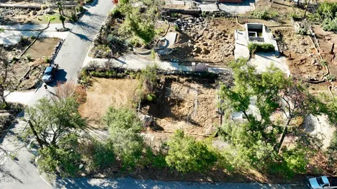 an aerial view of a residential houses with outdoor space