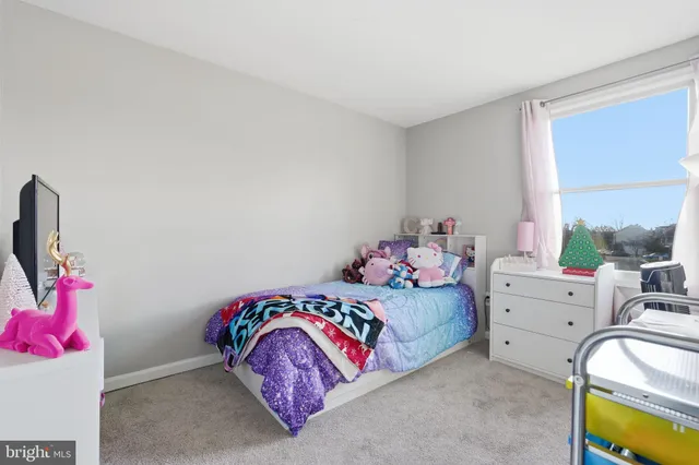 a bedroom with a bed and a potted plant
