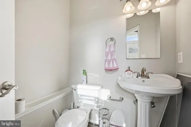 a bathroom with a sink a toilet and mirror