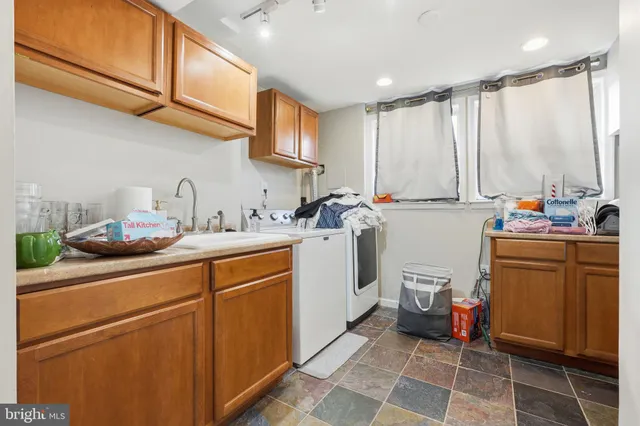 a room with sink washer and dryer