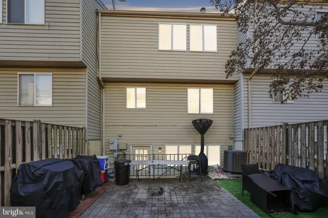 a front view of a house with a garden and chairs