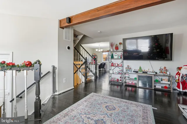a living room with lots of furniture and wooden floor