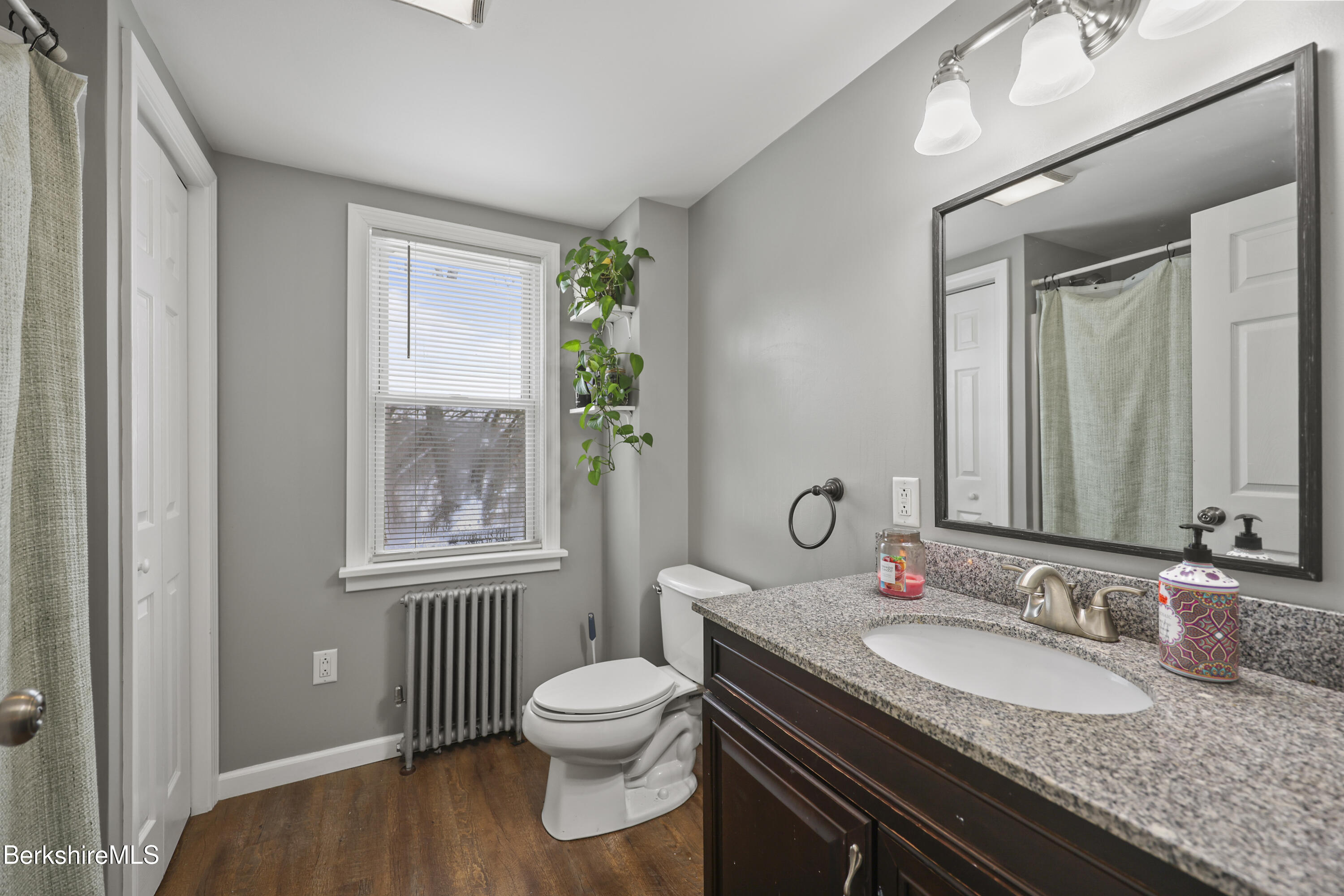 40 Stearns Avenue Pittsfield, MA 01201 - Photo 15 of 25 a bathroom with a granite countertop sink a toilet and a mirror