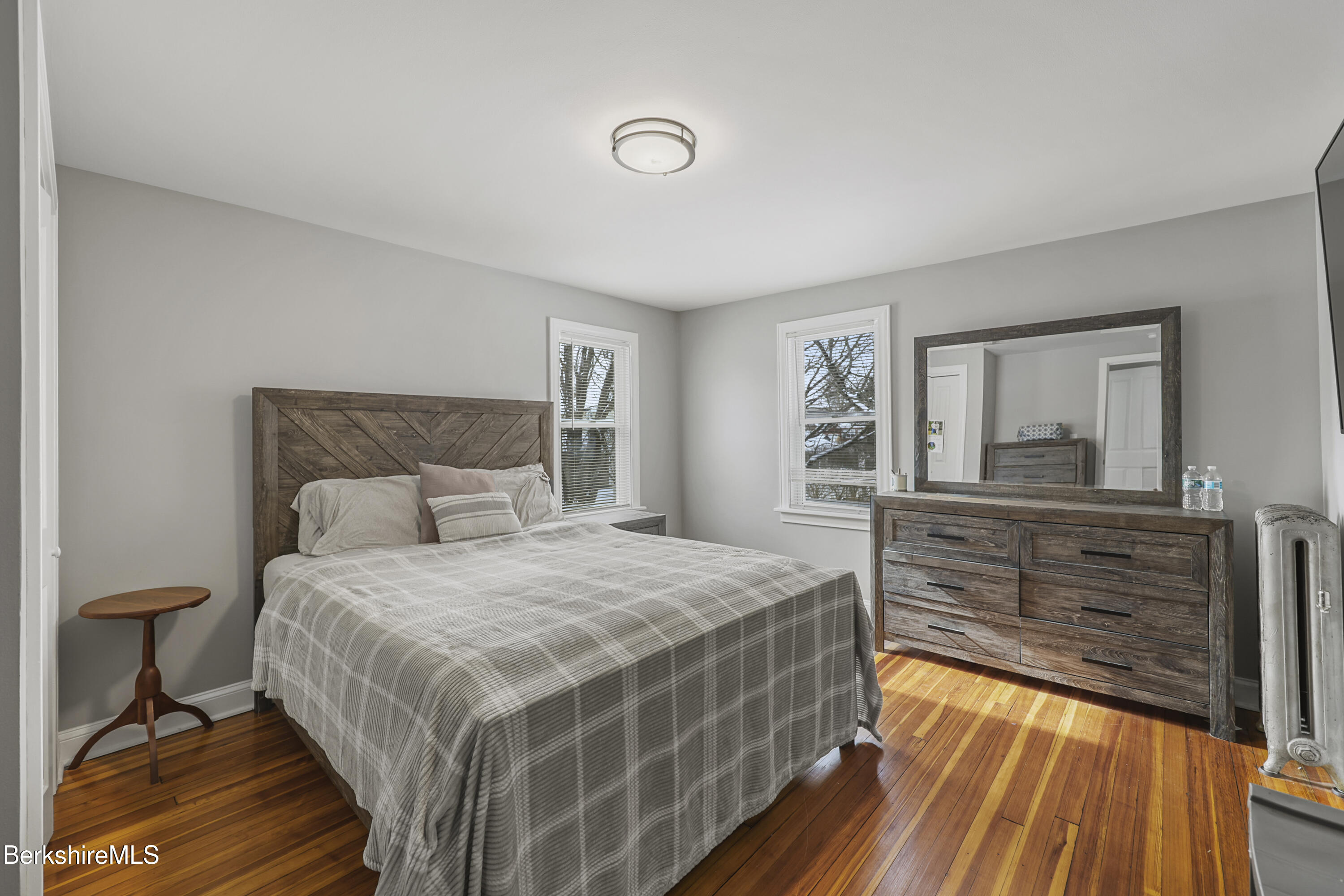 40 Stearns Avenue Pittsfield, MA 01201 - Photo 16 of 25 a bedroom with a bed and a dresser with mirror