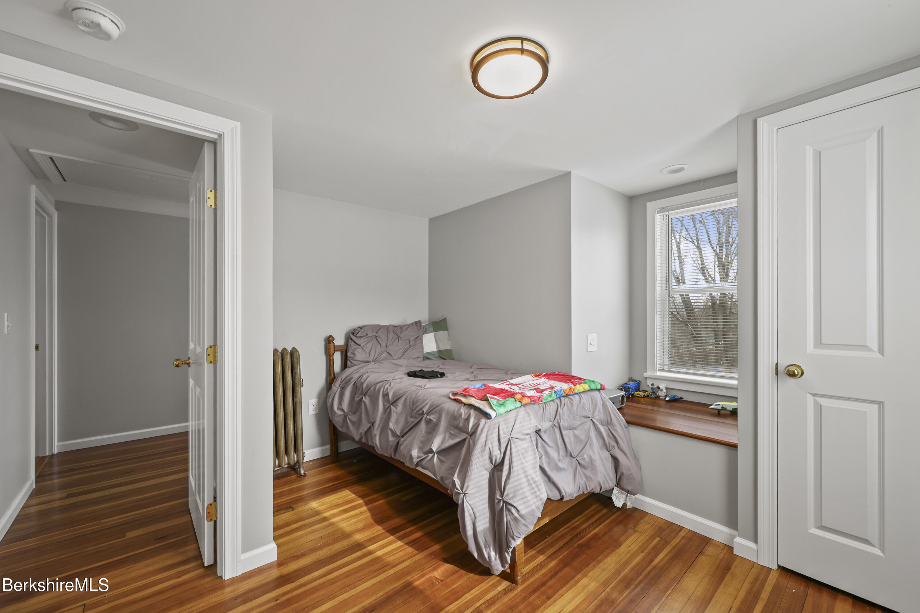 40 Stearns Avenue Pittsfield, MA 01201 - Photo 21 of 25 a bedroom with a bed and wooden floor