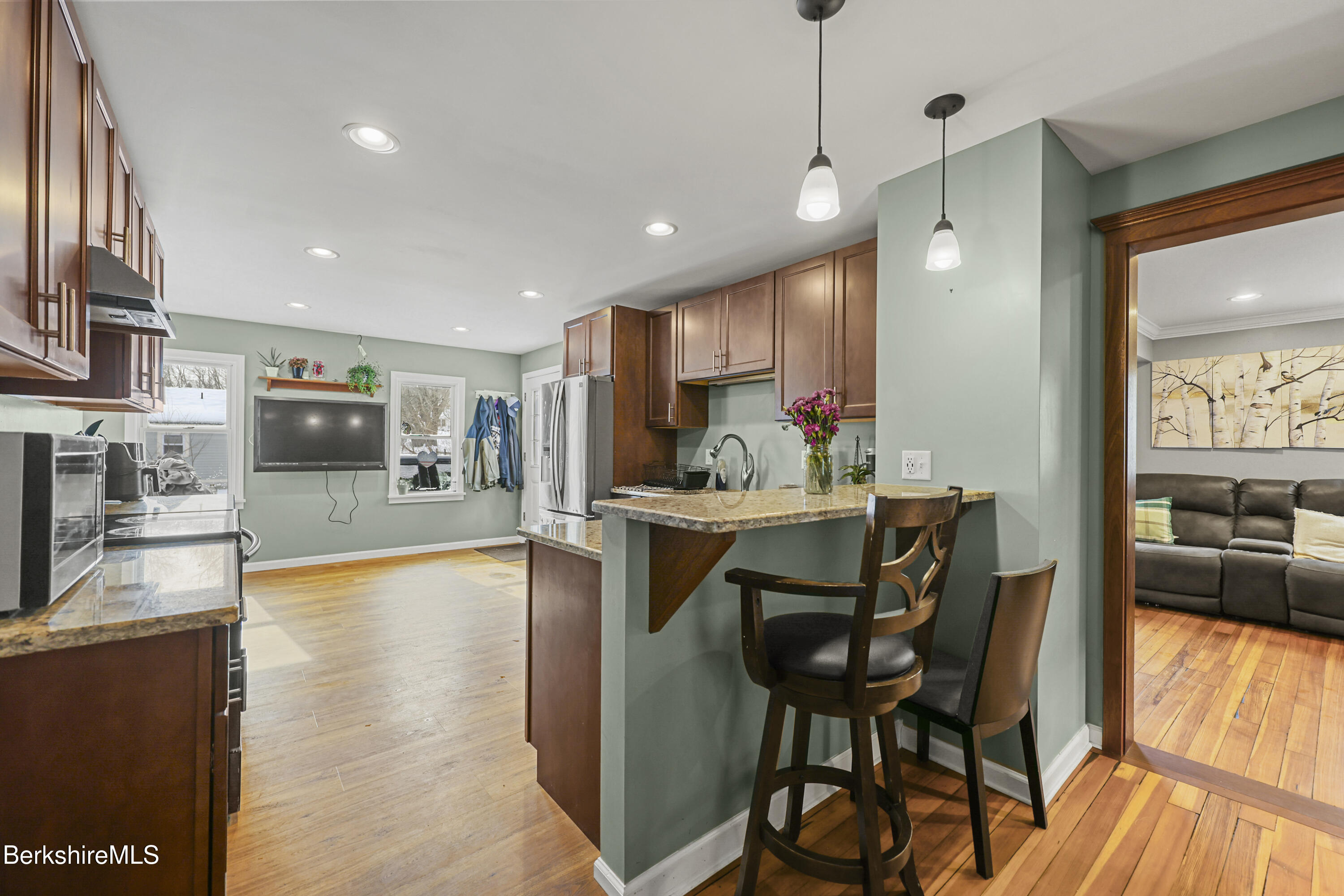 40 Stearns Avenue Pittsfield, MA 01201 - Photo 5 of 25 a kitchen with stainless steel appliances granite countertop table chairs stove and refrigerator