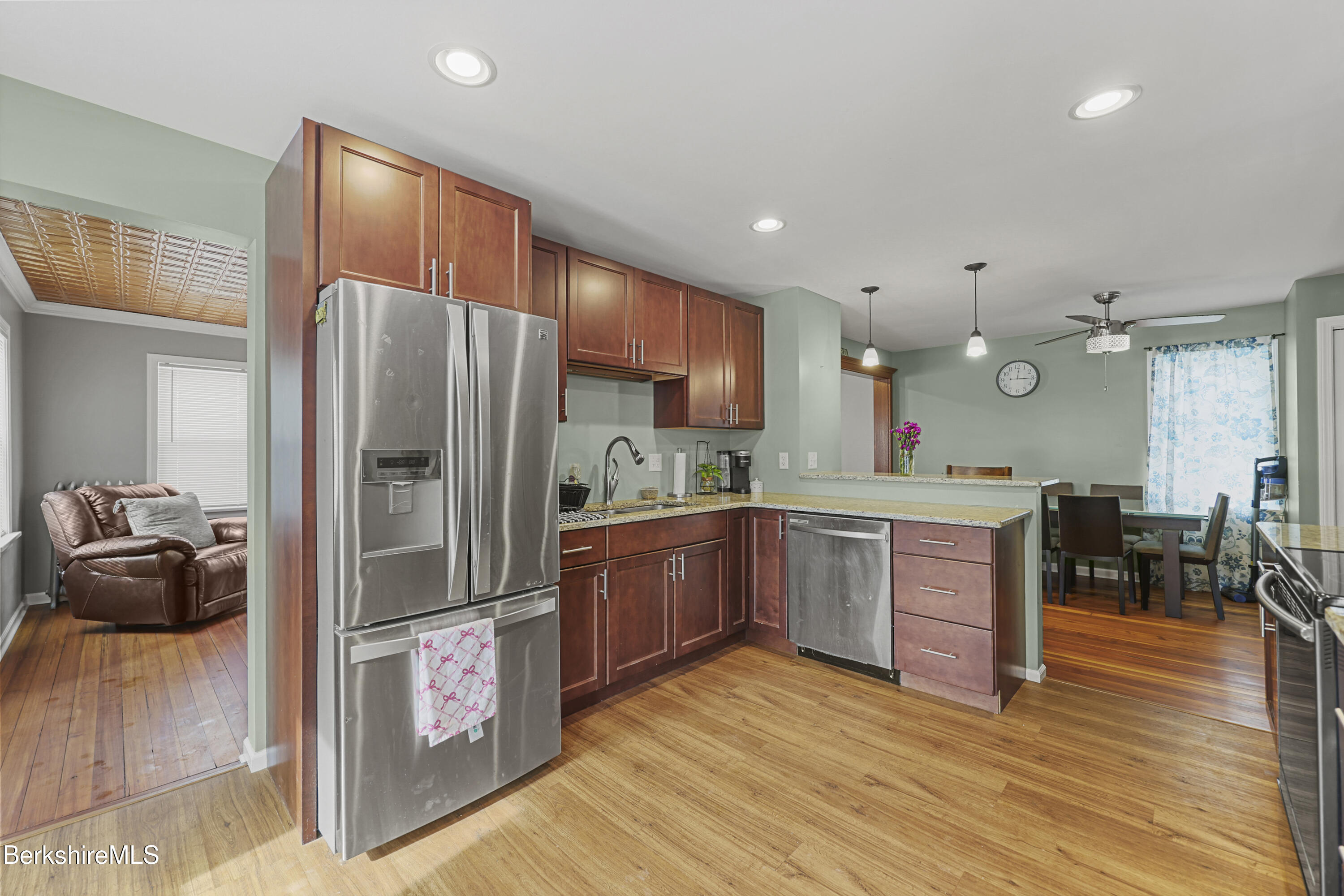 40 Stearns Avenue Pittsfield, MA 01201 - Photo 7 of 25 a kitchen with stainless steel appliances kitchen island granite countertop a refrigerator and a stove top oven