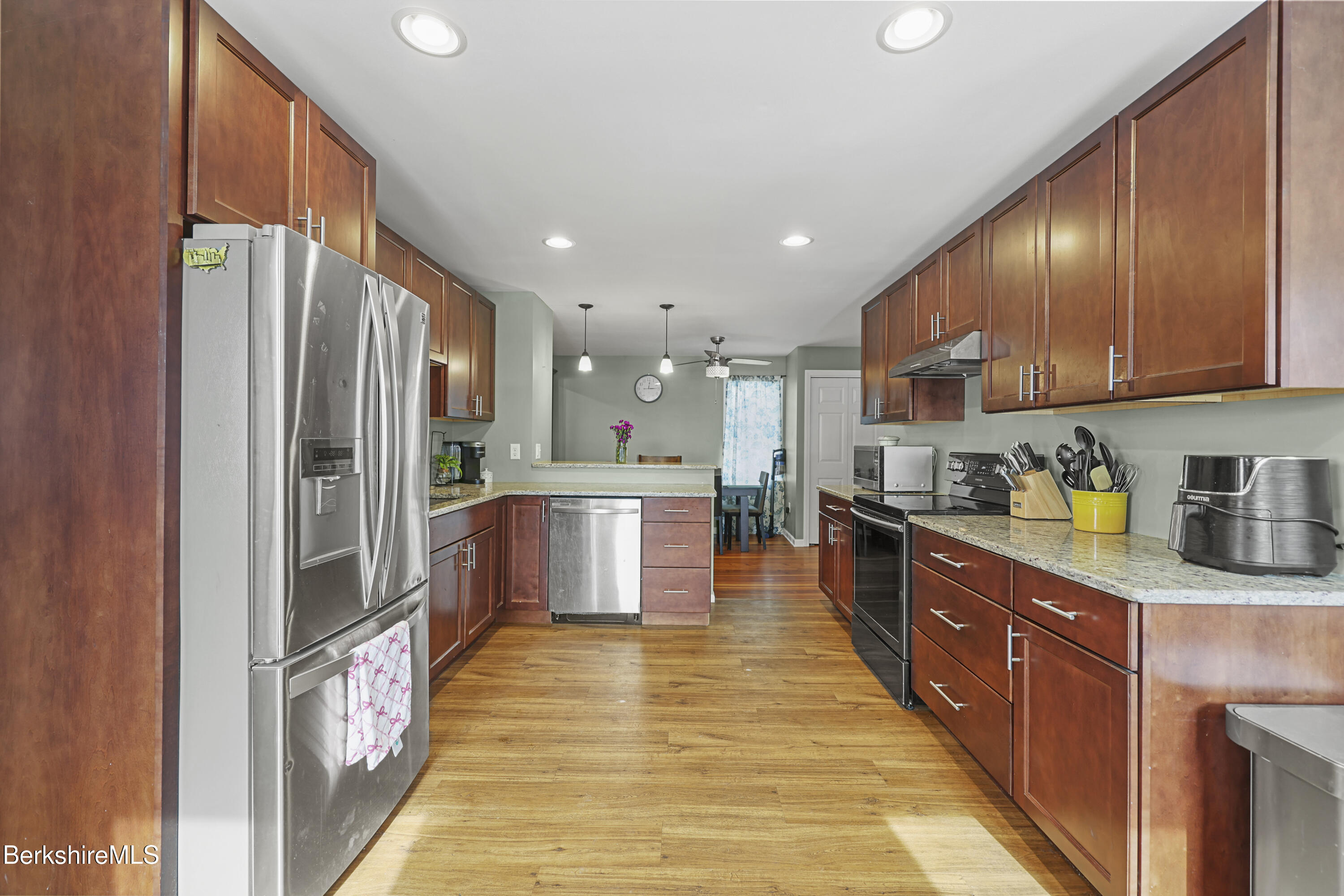 40 Stearns Avenue Pittsfield, MA 01201 - Photo 8 of 25 a large kitchen with stainless steel appliances kitchen island granite countertop a large counter top cabinets and a sink