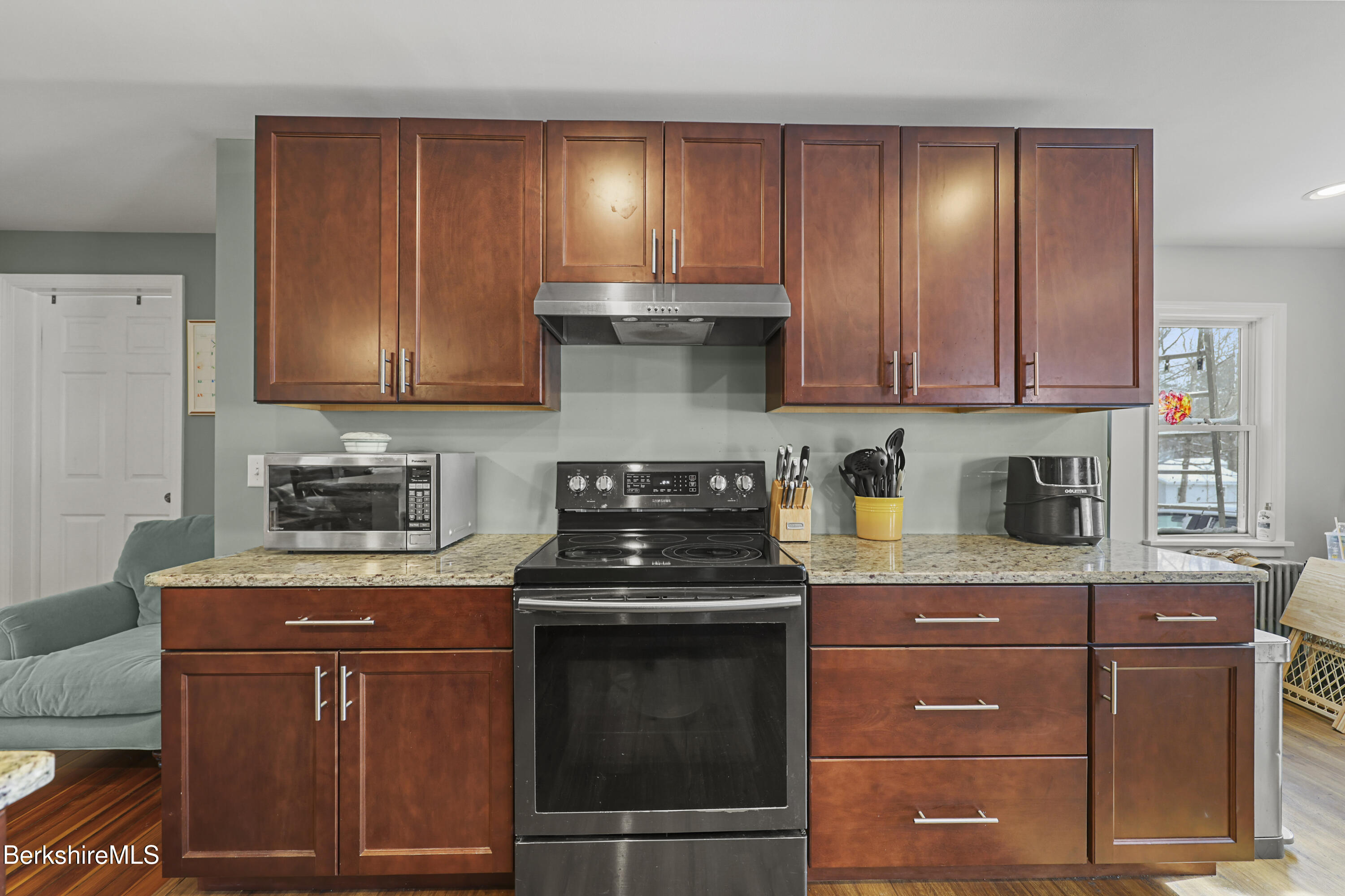 40 Stearns Avenue Pittsfield, MA 01201 - Photo 9 of 25 a kitchen with granite countertop wood cabinets and stainless steel appliances