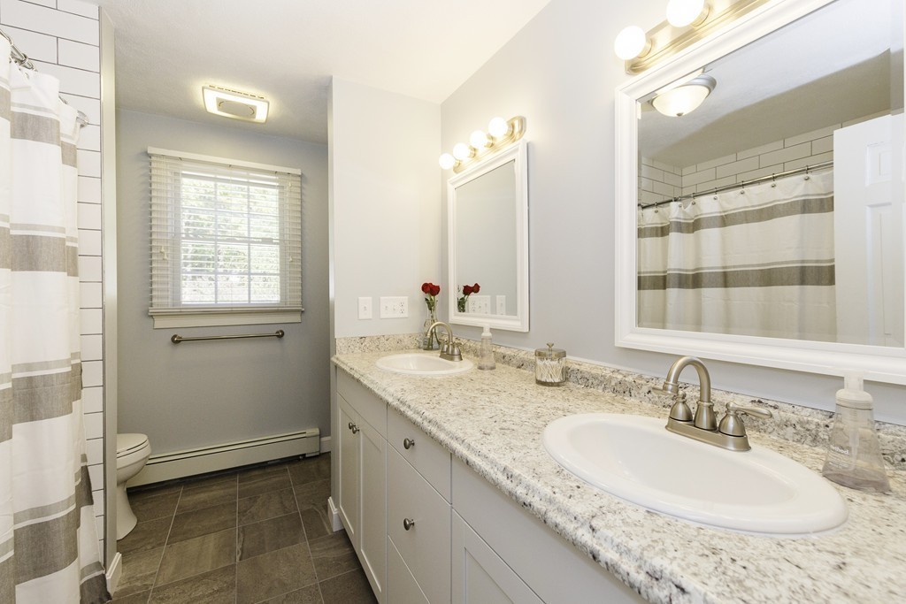 18 Paige Farm Road Amesbury, MA 01913 - Photo 16 of 28 a bathroom with a granite countertop sink and a mirror