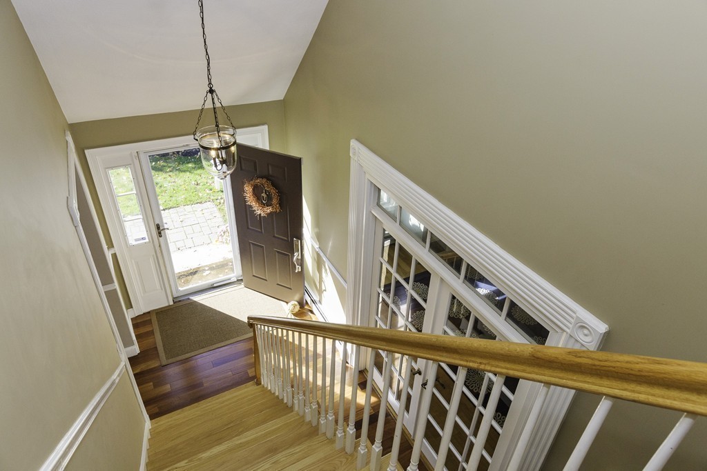 18 Paige Farm Road Amesbury, MA 01913 - Photo 19 of 28 a view of a hallway with wooden floor and staircase