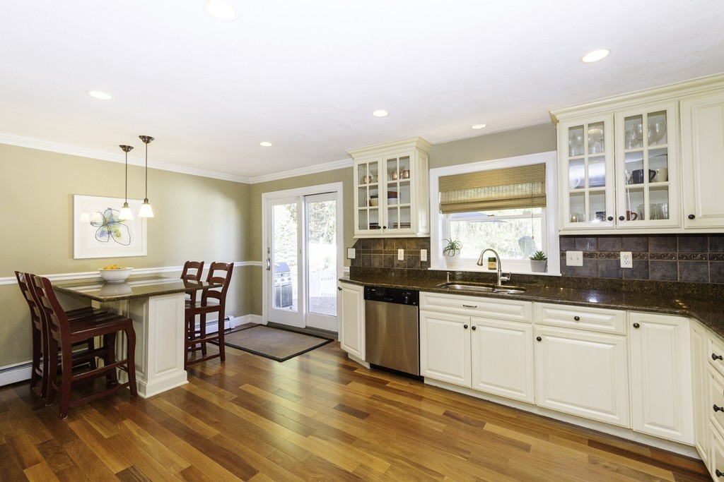 18 Paige Farm Road Amesbury, MA 01913 - Photo 7 of 28 a kitchen with granite countertop a sink cabinets and dining table