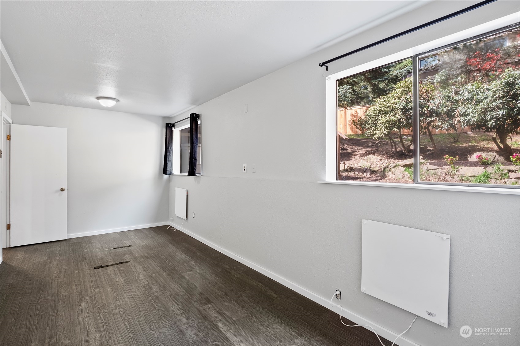21820 3rd Drive Southeast Bothell, WA 98021 - Photo 20 of 25 a view of an empty room with wooden floor and a window