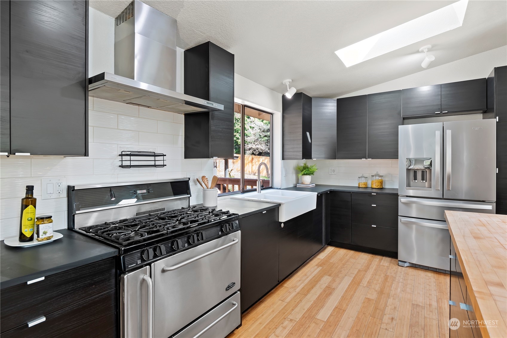 21820 3rd Drive Southeast Bothell, WA 98021 - Photo 10 of 25 a kitchen with stainless steel appliances granite countertop a stove refrigerator and cabinets