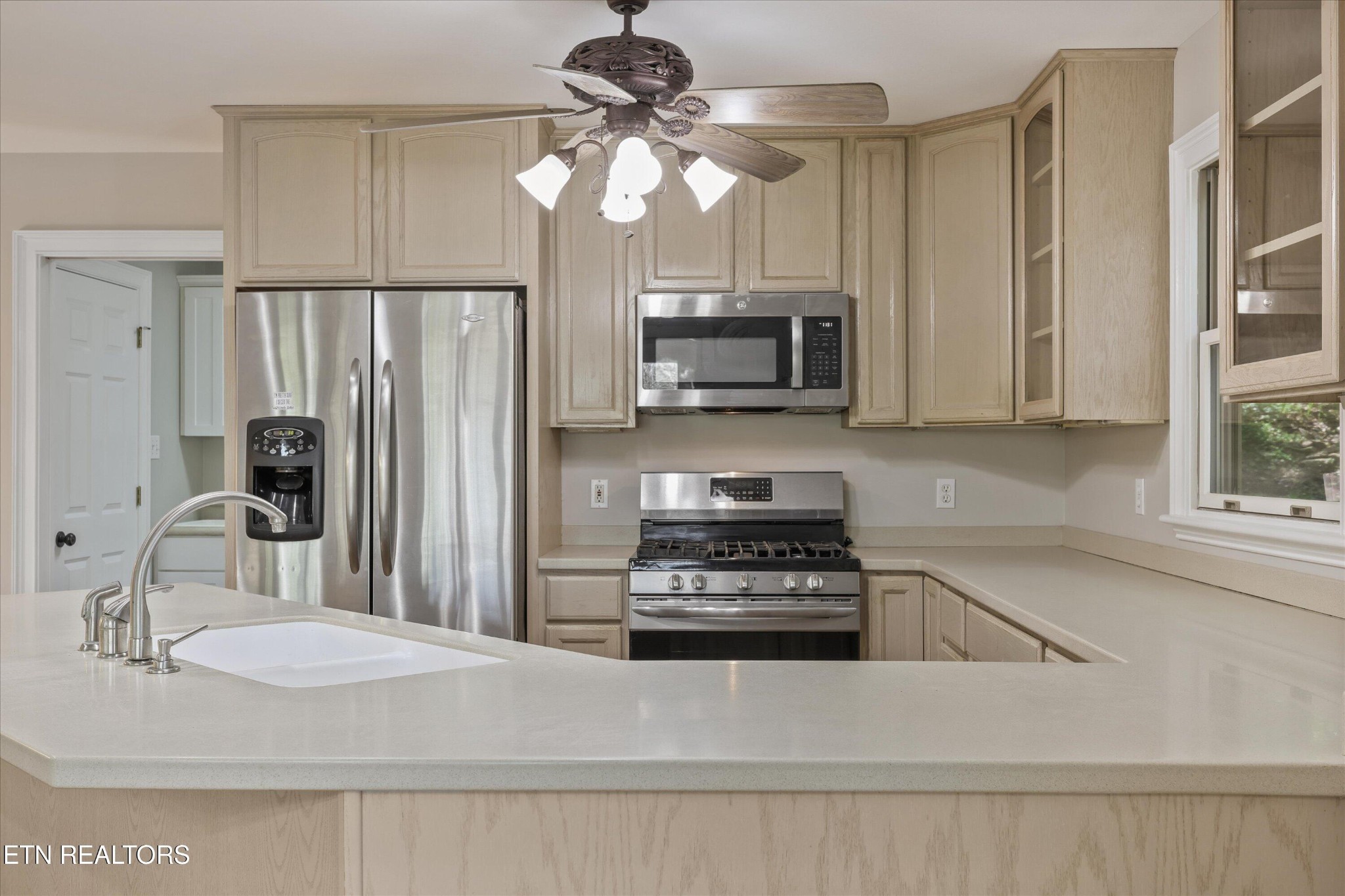 865 Stonegate Way Townsend, TN 37882 - Photo 21 of 60 a kitchen with stainless steel appliances a stove a sink a microwave and refrigerator